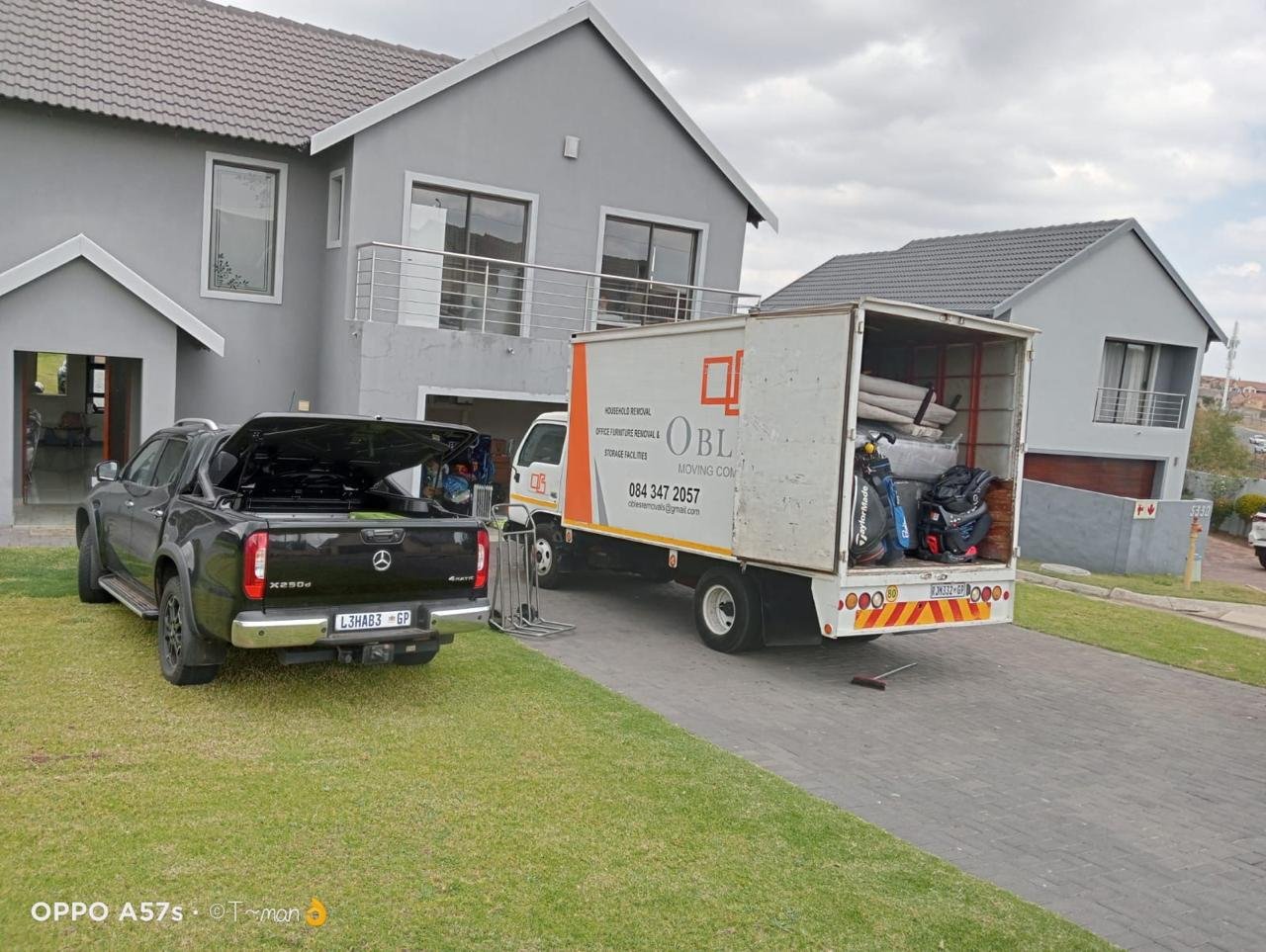 Moving truck parked at a home with loaded household items