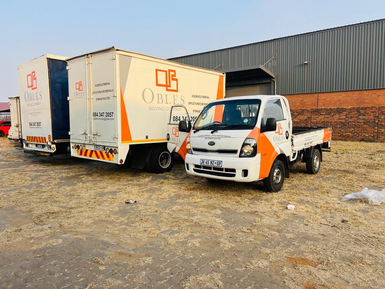 Obles Removals trucks parked together at a depot yard