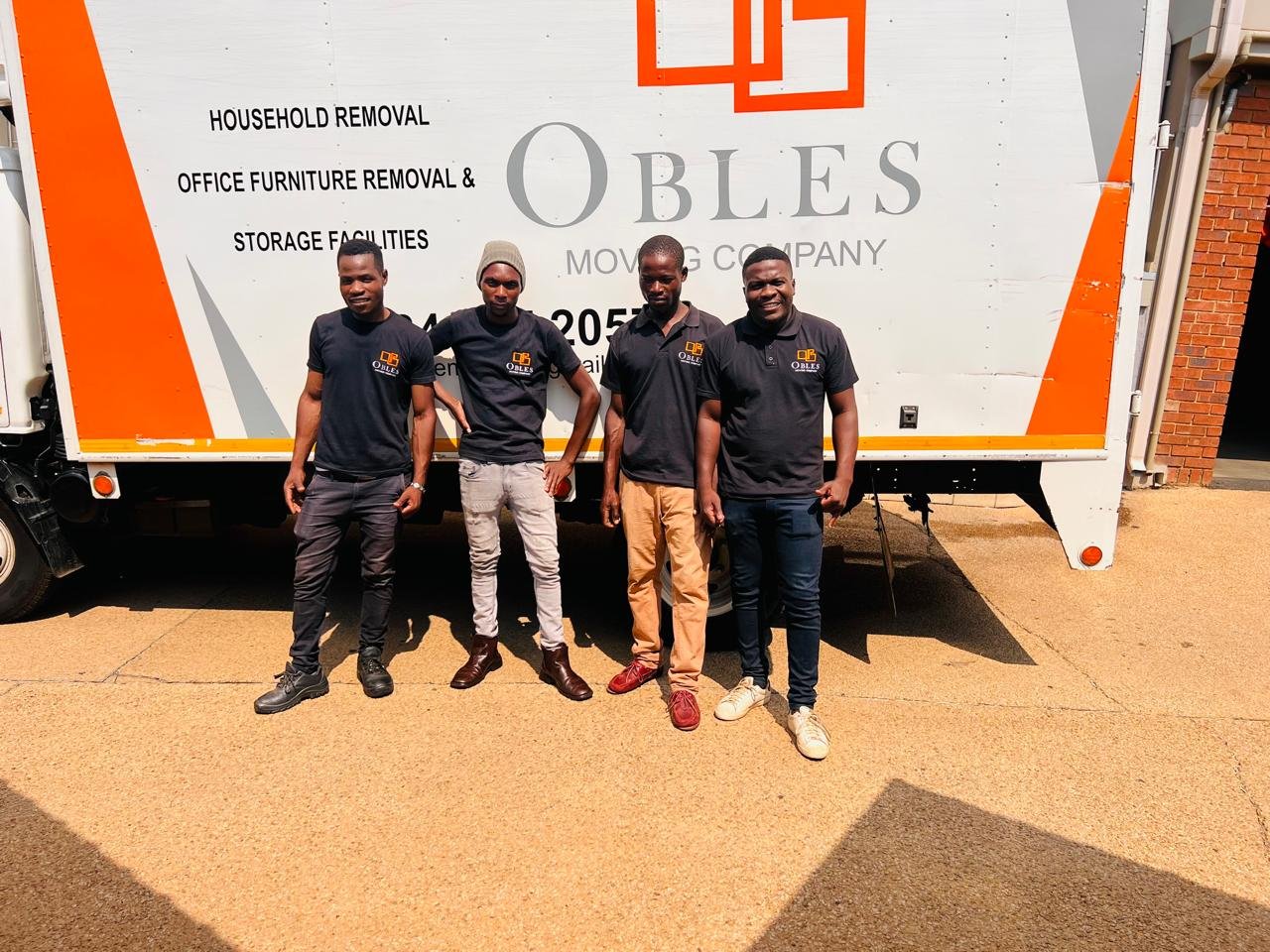 Obles Removals staff standing in front of a branded removal truck