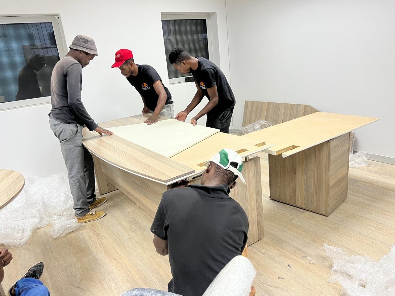 Obles Removals team assembling an office desk indoors