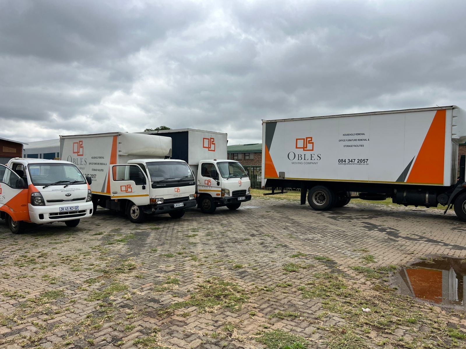 Obles Removals fleet of branded trucks parked together
